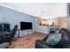 Open living room showcasing hardwood floors, bar seating, and kitchen at 3707 Conroy Rd # 1715, Orlando, FL 32839