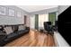 Living room with hardwood floors, leather couch, television, and decor at 3707 Conroy Rd # 1715, Orlando, FL 32839