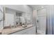 Elegant bathroom with double sinks, quartz countertop, walk-in shower and modern neutral decor at 3711 Bluethread Way, Poinciana, FL 34759