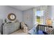 Charming Bedroom featuring a modern crib, dresser, and a serene outdoor view from the window at 3711 Bluethread Way, Poinciana, FL 34759