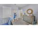 Charming Bedroom features a nautical theme, complemented by calming light blue walls and a spacious dresser at 3711 Bluethread Way, Poinciana, FL 34759