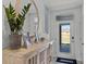 Inviting entryway features stylish decor, a wooden console table, and a round mirror at 3711 Bluethread Way, Poinciana, FL 34759