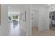 Bright hallway with tile floors, decorative artwork and provides access to living areas at 3711 Bluethread Way, Poinciana, FL 34759