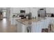 Modern kitchen with white cabinets, stainless steel appliances, and an island with seating at 3711 Bluethread Way, Poinciana, FL 34759