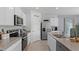 Bright kitchen with stainless steel appliances, white cabinets, and spacious countertops at 3711 Bluethread Way, Poinciana, FL 34759