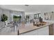 Stylish kitchen with a center island and an open view to the dining and living space at 3711 Bluethread Way, Poinciana, FL 34759