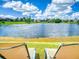 Relaxing backyard view overlooking a serene lake, offering a peaceful escape from comfortable lounge chairs at 3728 Hunters Isle Dr, Orlando, FL 32837