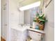 Bathroom features vanity, toilet, and glass block window that lets in light while ensuring privacy at 3728 Hunters Isle Dr, Orlando, FL 32837
