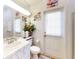 Bright bathroom features a single vanity, seashell decor, and a convenient door to the outside at 3728 Hunters Isle Dr, Orlando, FL 32837