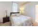 Cozy bedroom featuring neutral decor, soft lighting, and a comfortable queen-size bed and unique window at 3728 Hunters Isle Dr, Orlando, FL 32837