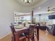 Cozy dining space with views of the pool and adjacent living area, ideal for Gathering gatherings at 3728 Hunters Isle Dr, Orlando, FL 32837