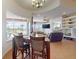 Elegant dining room with water views, chandelier lighting and open layout to the adjacent living room at 3728 Hunters Isle Dr, Orlando, FL 32837