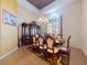 Formal dining room with ornate hutch, elegant seating, and a decorative chandelier, perfect for gatherings at 3728 Hunters Isle Dr, Orlando, FL 32837