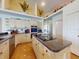 Bright kitchen featuring decorative shelving, white cabinets, and modern stainless steel appliances at 3728 Hunters Isle Dr, Orlando, FL 32837