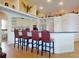 Kitchen featuring a breakfast bar with seating, built-in appliances, and decorative display shelves at 3728 Hunters Isle Dr, Orlando, FL 32837