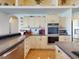 Modern kitchen with an island cooktop, granite countertops, and stainless steel appliances at 3728 Hunters Isle Dr, Orlando, FL 32837