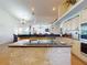 Open-concept kitchen with a cooktop island and a seamless view into the adjacent living areas at 3728 Hunters Isle Dr, Orlando, FL 32837