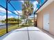 Screened lanai offering a relaxing retreat with scenic lake views, complemented by comfortable seating at 3728 Hunters Isle Dr, Orlando, FL 32837