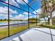 Enjoy the serene lake view from this spacious lanai with beautiful landscaping and a relaxing atmosphere at 3728 Hunters Isle Dr, Orlando, FL 32837