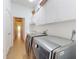 Spacious laundry room with storage cabinets, stainless steel appliances, and tile flooring for easy maintenance at 3728 Hunters Isle Dr, Orlando, FL 32837