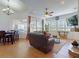 Open-concept living space with dining area, living room seating and beautiful views of the outdoor space at 3728 Hunters Isle Dr, Orlando, FL 32837