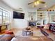 Cozy living room features a stone fireplace, built in shelves, and comfortable leather seating at 3728 Hunters Isle Dr, Orlando, FL 32837