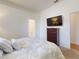 Comfortable main bedroom with a tv, and ensuite bathroom is well-lit and features neutral tones at 3728 Hunters Isle Dr, Orlando, FL 32837