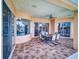 Enjoy outdoor dining on this covered patio with tile flooring, a ceiling fan, and view of the pool at 3728 Hunters Isle Dr, Orlando, FL 32837