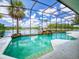 Screened-in pool offers a beautiful waterfront view, a rock waterfall feature, and an inviting space for leisure at 3728 Hunters Isle Dr, Orlando, FL 32837