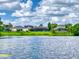 Tranquil waterfront view showcasing well-maintained homes and landscaping along the serene lake at 3728 Hunters Isle Dr, Orlando, FL 32837