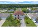 Aerial view of the charming two-story home with a well-manicured lawn and mature landscaping, set in a quiet neighborhood at 404 Bar Ct, Kissimmee, FL 34759