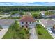 Aerial view of the charming two-story home with a well-manicured lawn and mature landscaping, set in a quiet neighborhood at 404 Bar Ct, Kissimmee, FL 34759