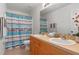Inviting bathroom offers dual sinks and shower with decorative curtain at 404 Bar Ct, Kissimmee, FL 34759