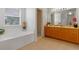 Bright bathroom featuring a soaking tub, walk-in shower, and dual vanities at 404 Bar Ct, Kissimmee, FL 34759