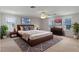 Serene bedroom with a dark wood bed frame, a ceiling fan, and bright natural light at 404 Bar Ct, Kissimmee, FL 34759