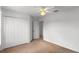 Carpeted bedroom includes a closet and easy access to other rooms at 404 Bar Ct, Kissimmee, FL 34759