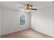 Neutrally painted bedroom features ceiling fan and window at 404 Bar Ct, Kissimmee, FL 34759