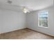 Carpeted bedroom features a large window for natural light and comfort at 404 Bar Ct, Kissimmee, FL 34759