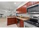 Well-equipped kitchen with stainless steel appliances, wood cabinetry and a breakfast bar area overlooking the living space at 404 Bar Ct, Kissimmee, FL 34759
