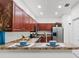 Stylish kitchen featuring wood cabinets, stainless steel appliances, and a breakfast bar with decorative place settings at 404 Bar Ct, Kissimmee, FL 34759