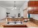 Open-concept kitchen with breakfast bar, stainless steel sink, and decorative accents at 404 Bar Ct, Kissimmee, FL 34759
