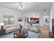 Bright and inviting living room with comfortable seating, a ceiling fan, and a glimpse of the kitchen at 404 Bar Ct, Kissimmee, FL 34759