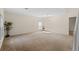 Spacious living room with plush carpeting and ample natural light showcases a comfortable and inviting atmosphere at 404 Bar Ct, Kissimmee, FL 34759
