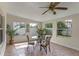 Bright sunroom featuring tile flooring, natural light, and a cozy dining area with views of the outdoors at 404 Bar Ct, Kissimmee, FL 34759