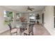 Relaxing sunroom with tile flooring, offering a serene space with a glass table and peaceful backyard views at 404 Bar Ct, Kissimmee, FL 34759