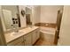 Bathroom featuring double sinks, a bathtub and tiled walls at 506 Mirasol Cir # 202, Celebration, FL 34747