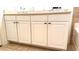 Bathroom vanity features white cabinets, beige countertop, dual sinks and is well-maintained in neutral tones at 506 Mirasol Cir # 202, Celebration, FL 34747