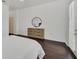 This bright bedroom features wood floors, a mirror, and door access to the outside at 506 Mirasol Cir # 202, Celebration, FL 34747