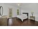 Bright bedroom with hardwood floors, ceiling fan and a door with access to the outside at 506 Mirasol Cir # 202, Celebration, FL 34747