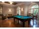 Common area showcasing a pool table, multiple couches, chairs, and exterior doors for lounging at 506 Mirasol Cir # 202, Celebration, FL 34747